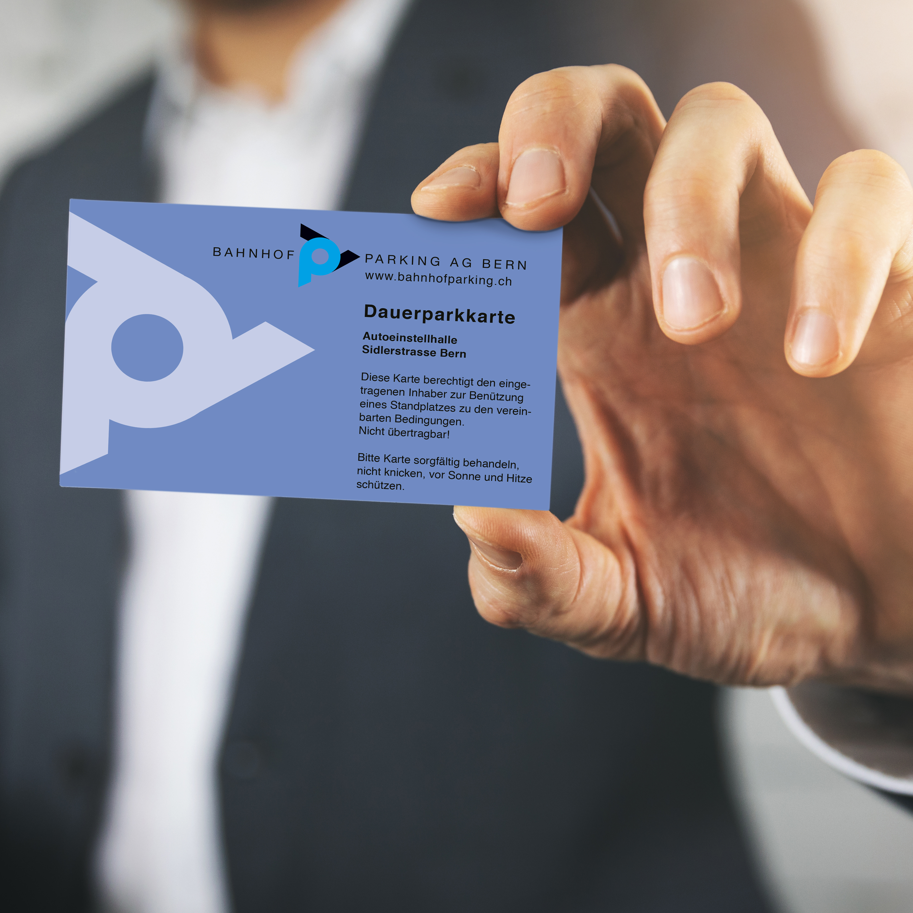 businessman hand showing blank white business card closeup